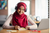 Teacher in a webinar making notes
